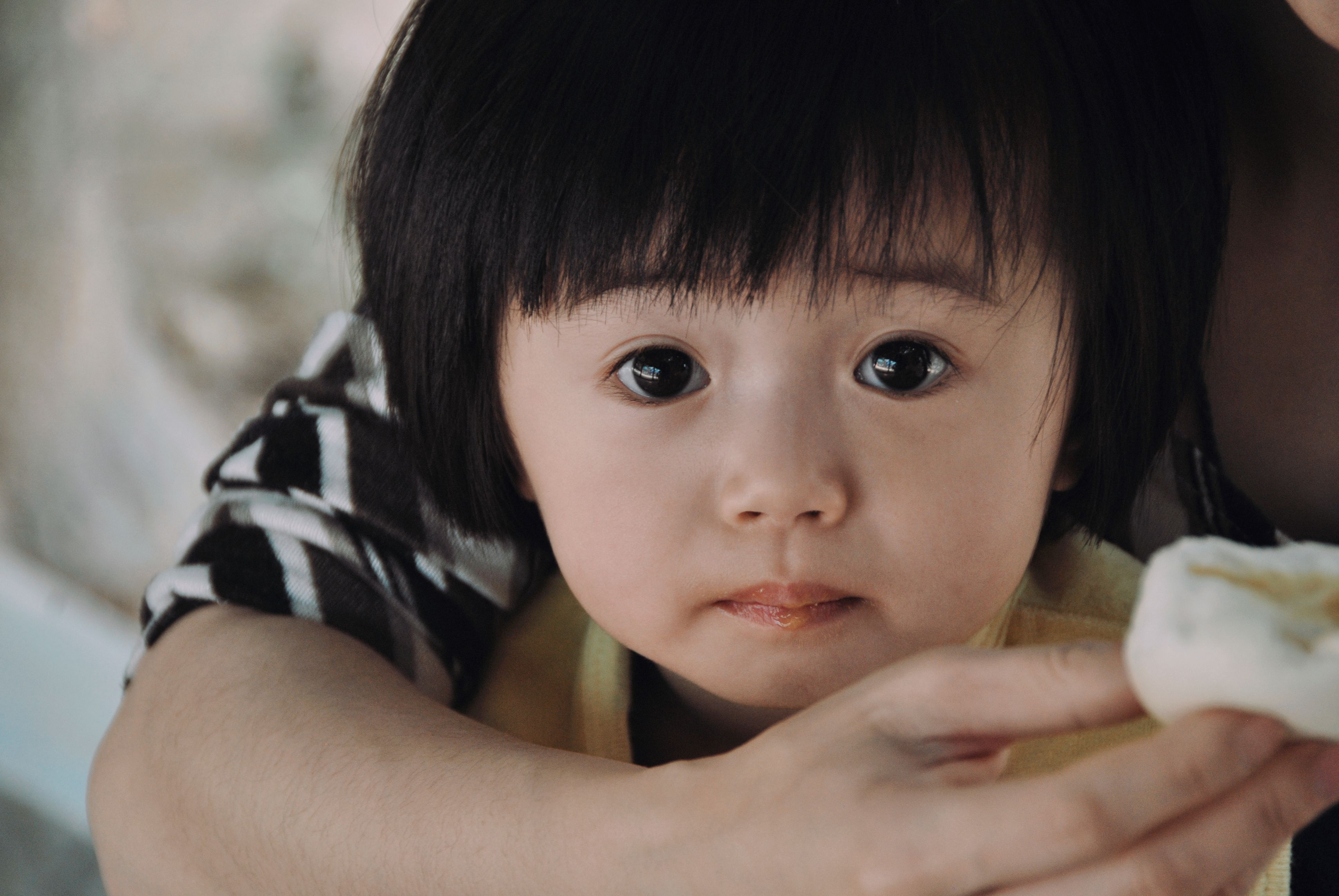 Young child looking at the camera, illustrating a discussion about Ortho-K for children with high myopia.